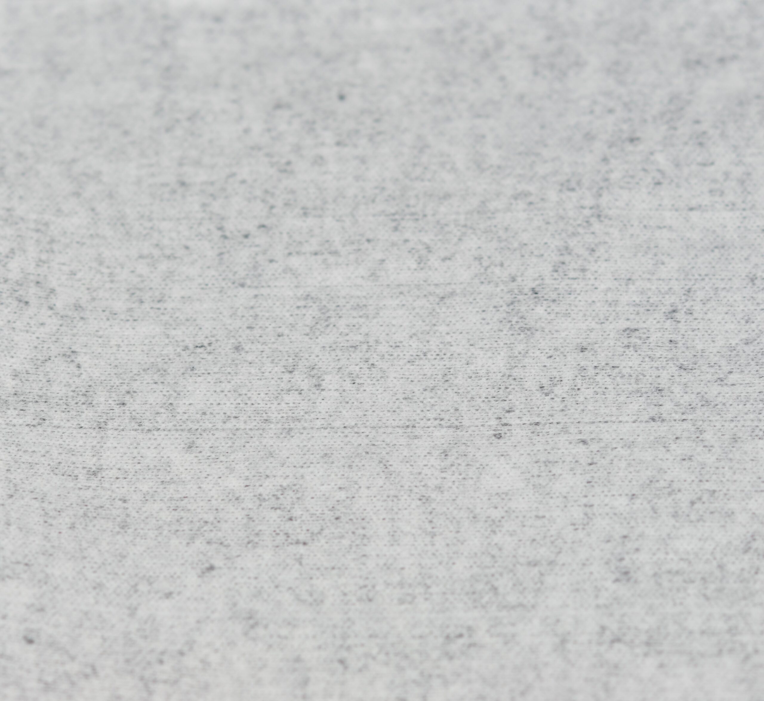 woodpulp polypropylene Woodpulp polypropylene nonwoven close-up photo showing the texture of a segment of white woodpulp polypropylene material.